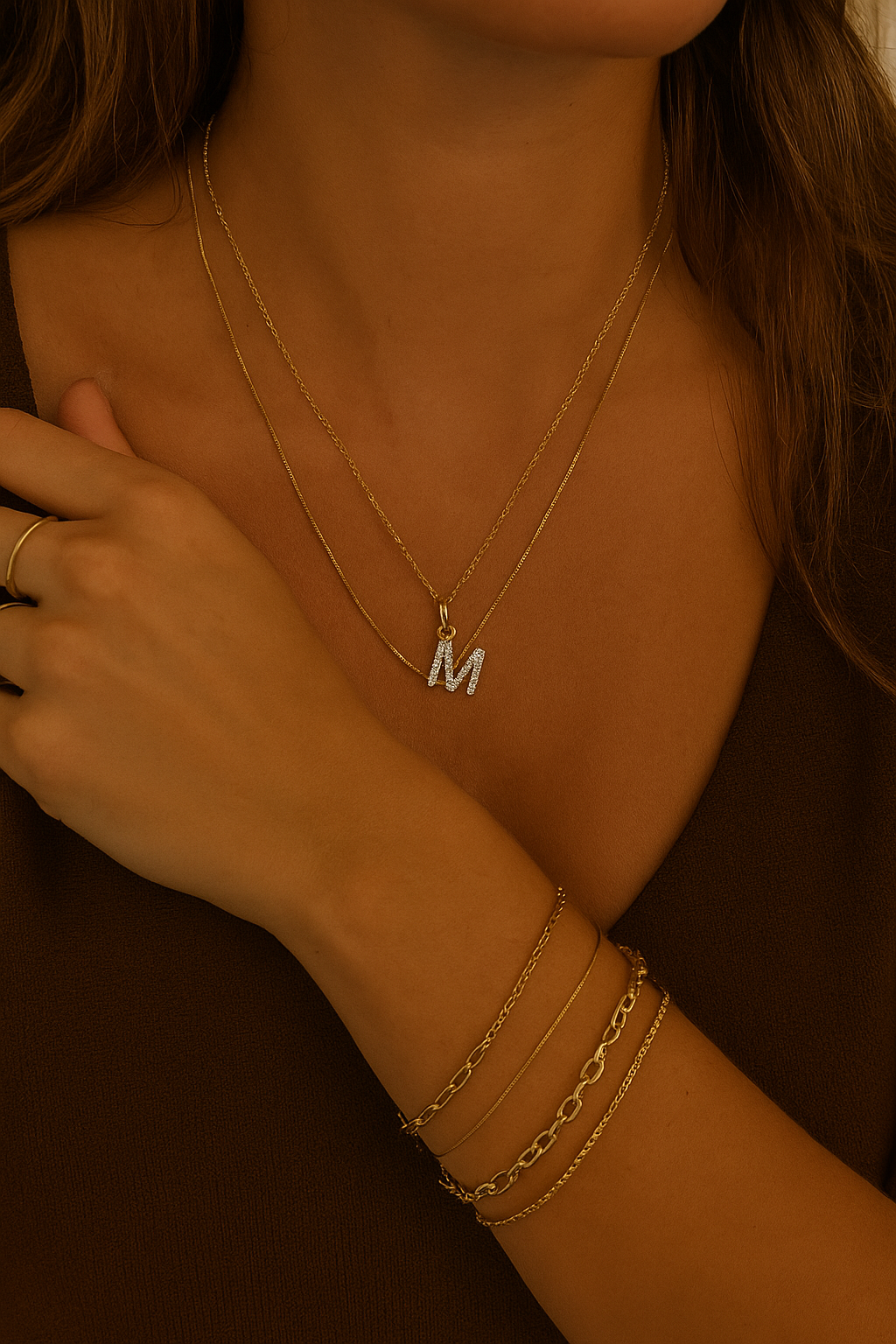 Close-up of a person wearing gold necklaces and bracelets with a blurred background